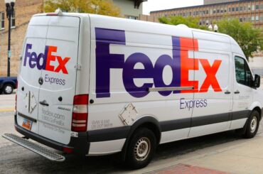 A FedEx van was Parked on the road.