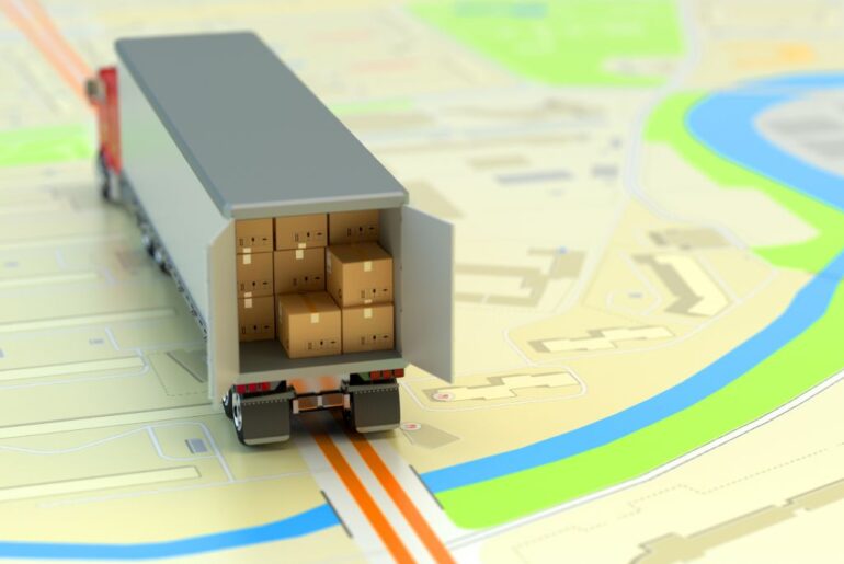 a delivery truck full of cardboard parcels on paper city map