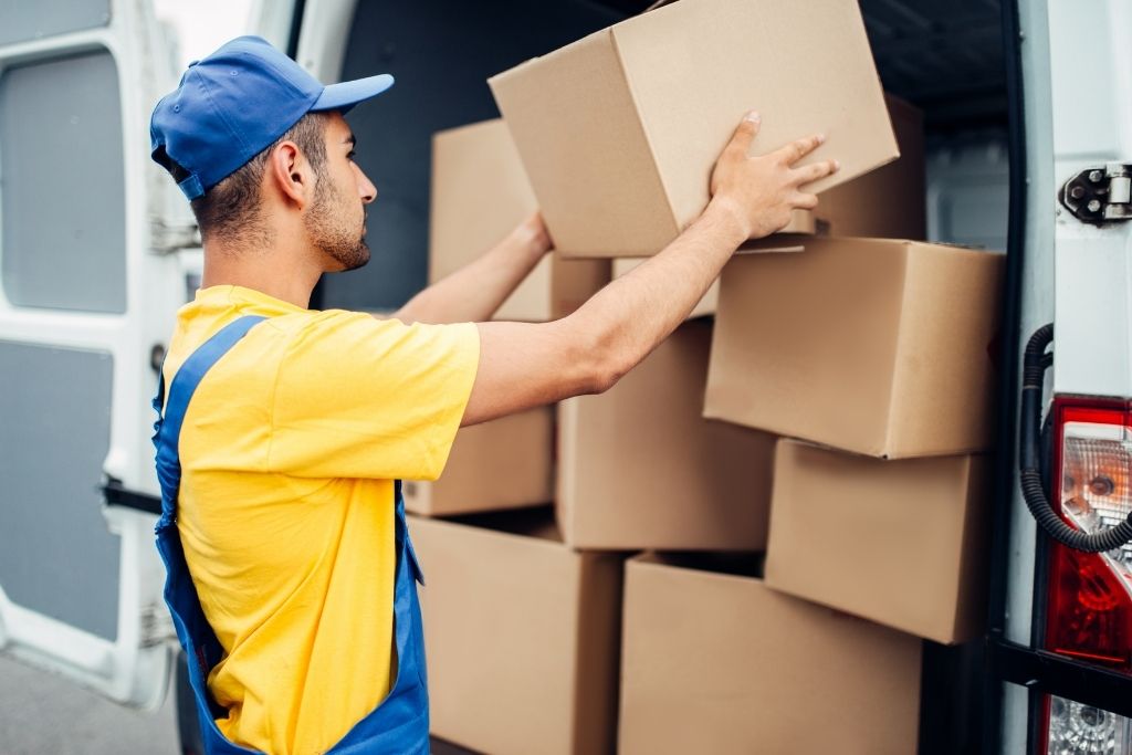 man stacking boxes for delivery