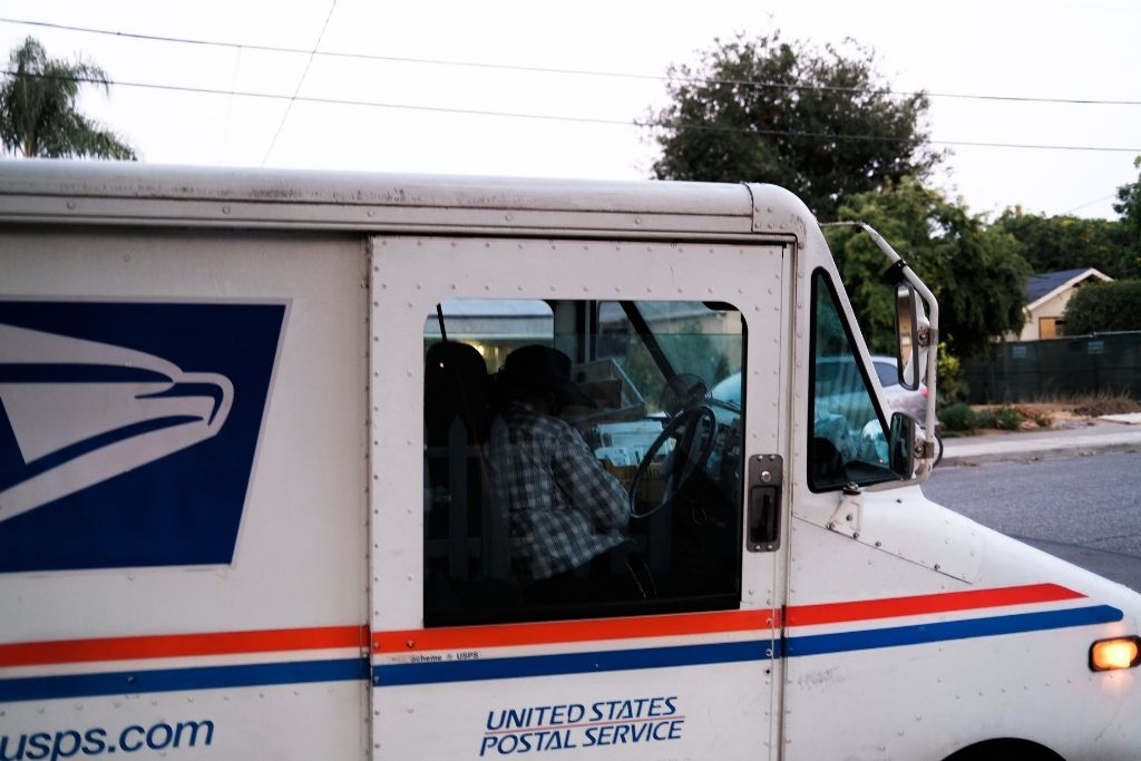 USPS delivery truck delivering packages