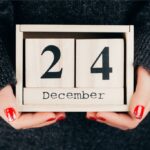 hand holding a wooden Christmas eve calendar