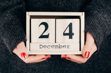 hand holding a wooden Christmas eve calendar